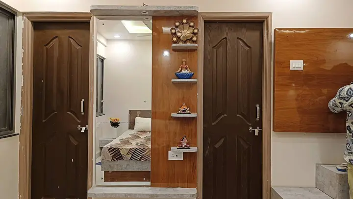 Doors to the bathroom with a mirror reflecting the bedroom